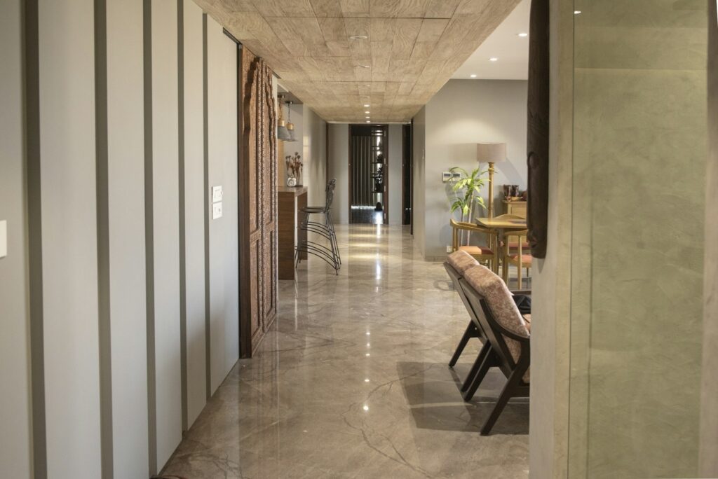 A long hallway with doors and furniture