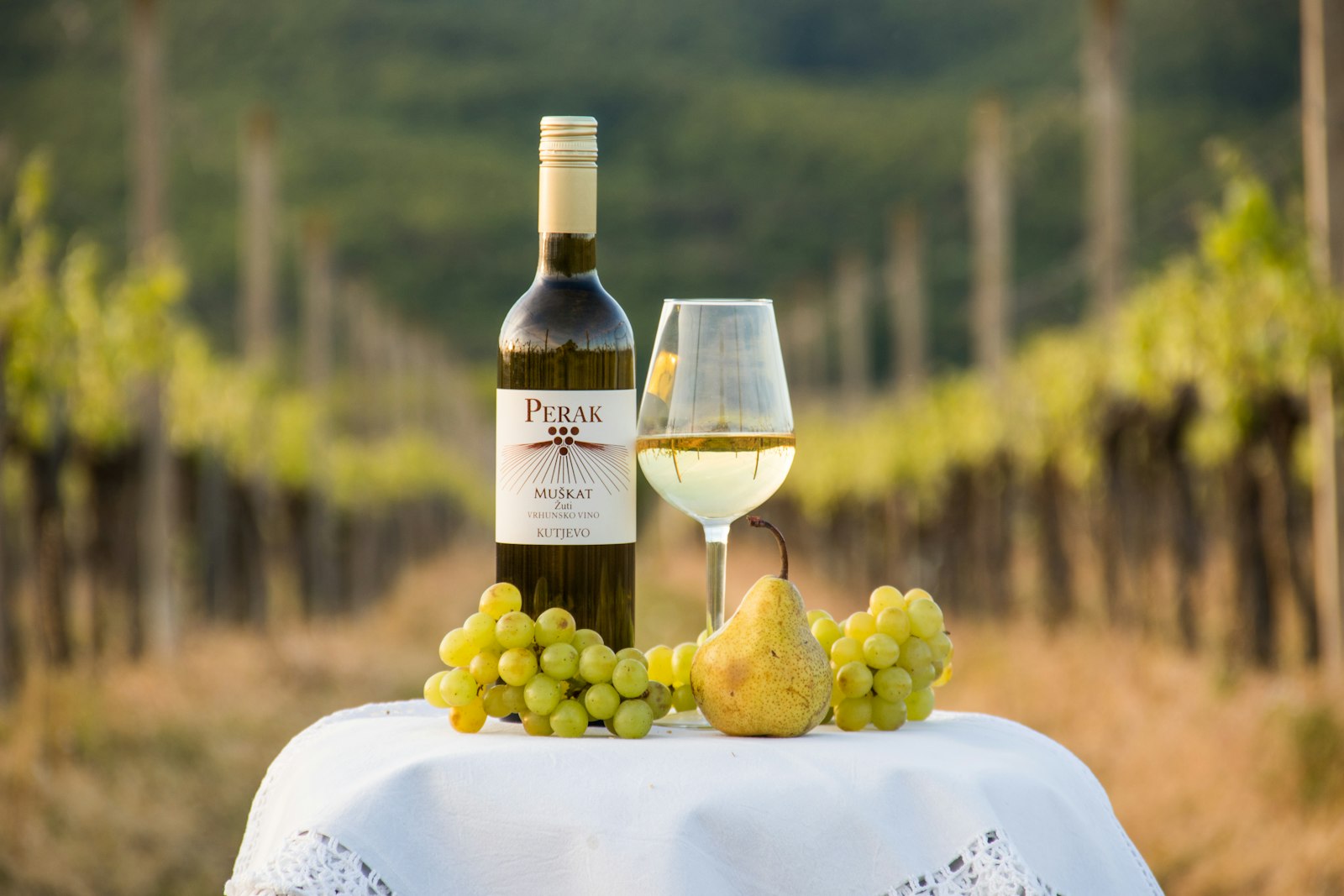A bottle of wine and a glass of wine on a table