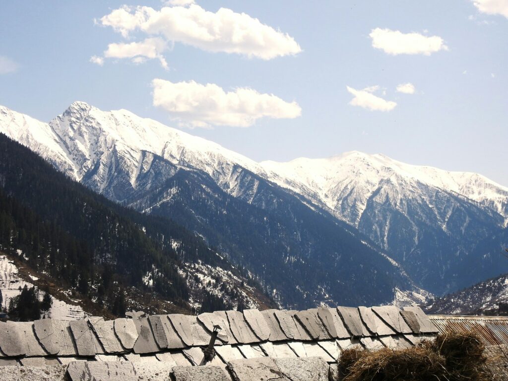 A view of a mountain range with a fence in the foreground