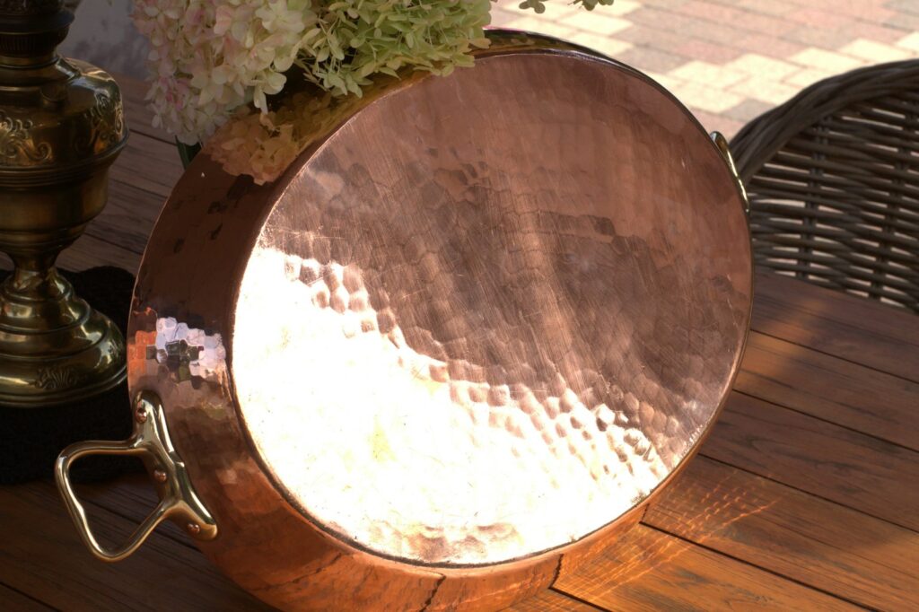 A large metal pan sitting on top of a wooden table