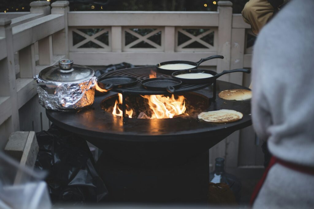 Frying pans on fire pit