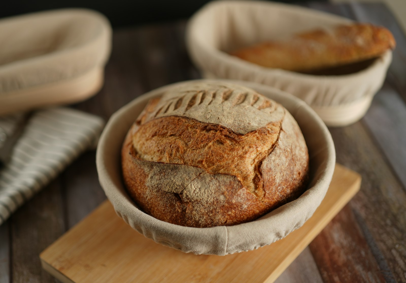 A loaf of bread sitting on top of a wooden cutting board