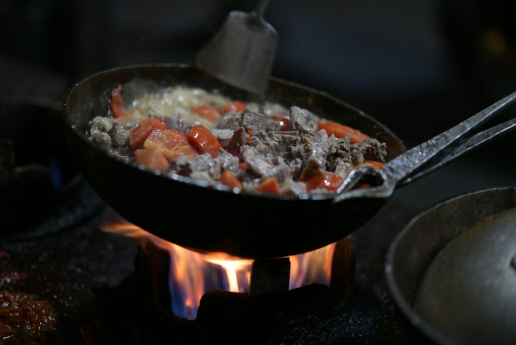 A skillet filled with food cooking on a stove