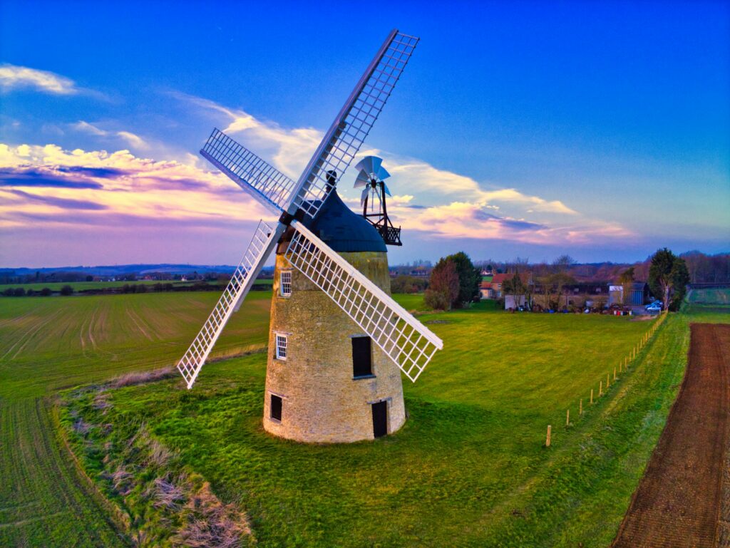 Wine mill at the field under blue and grey cloudy sky