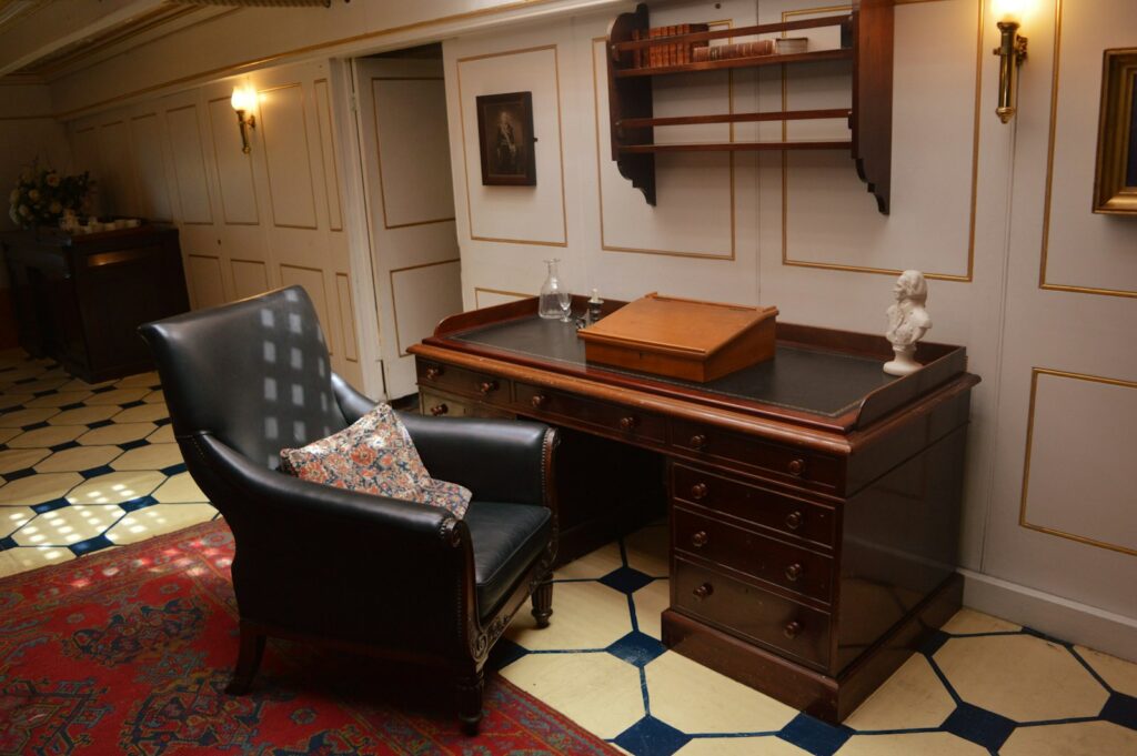 Elegant wooden desk and leather armchair in a classic study