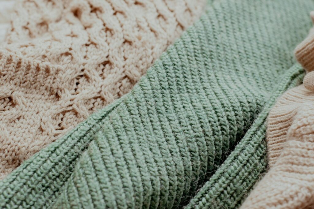 A close up of a knitted sweater and a knitted sweater
