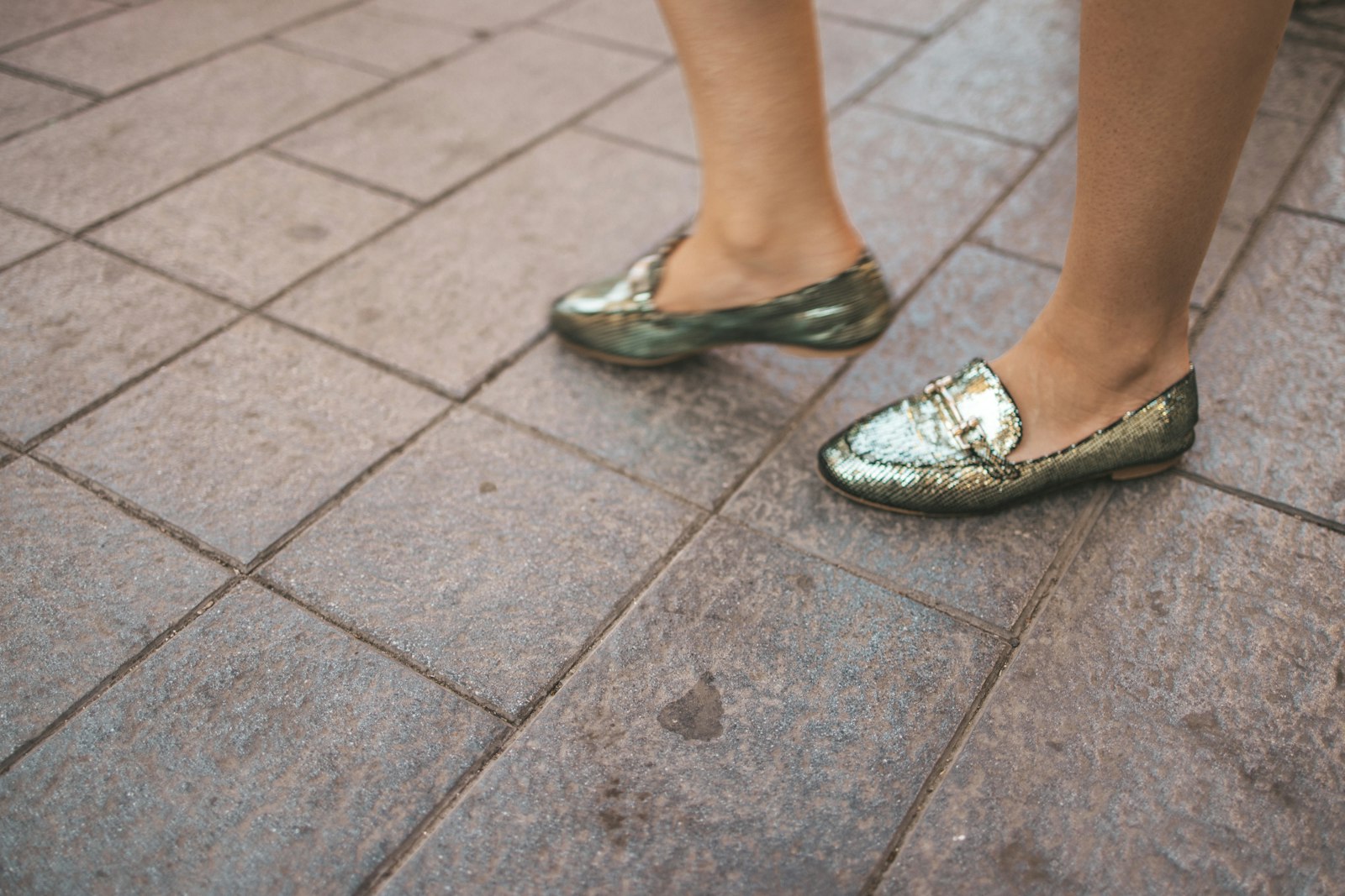 A close up of a person's shoes on the ground