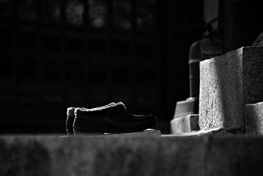 Black leather shoes on concrete blocks