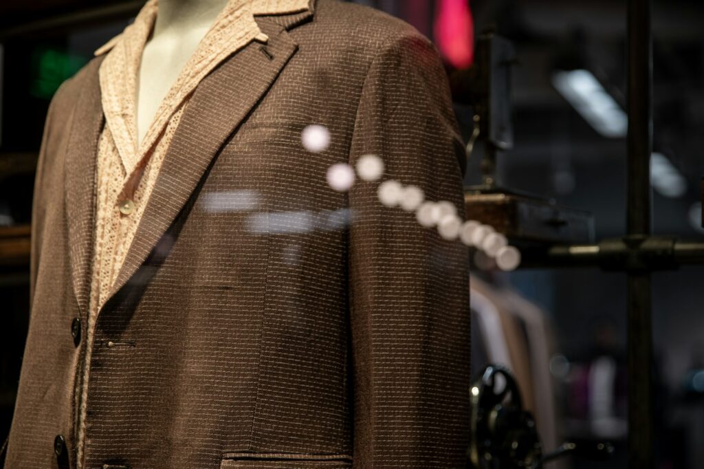 A mannequin dressed in a brown suit and hat