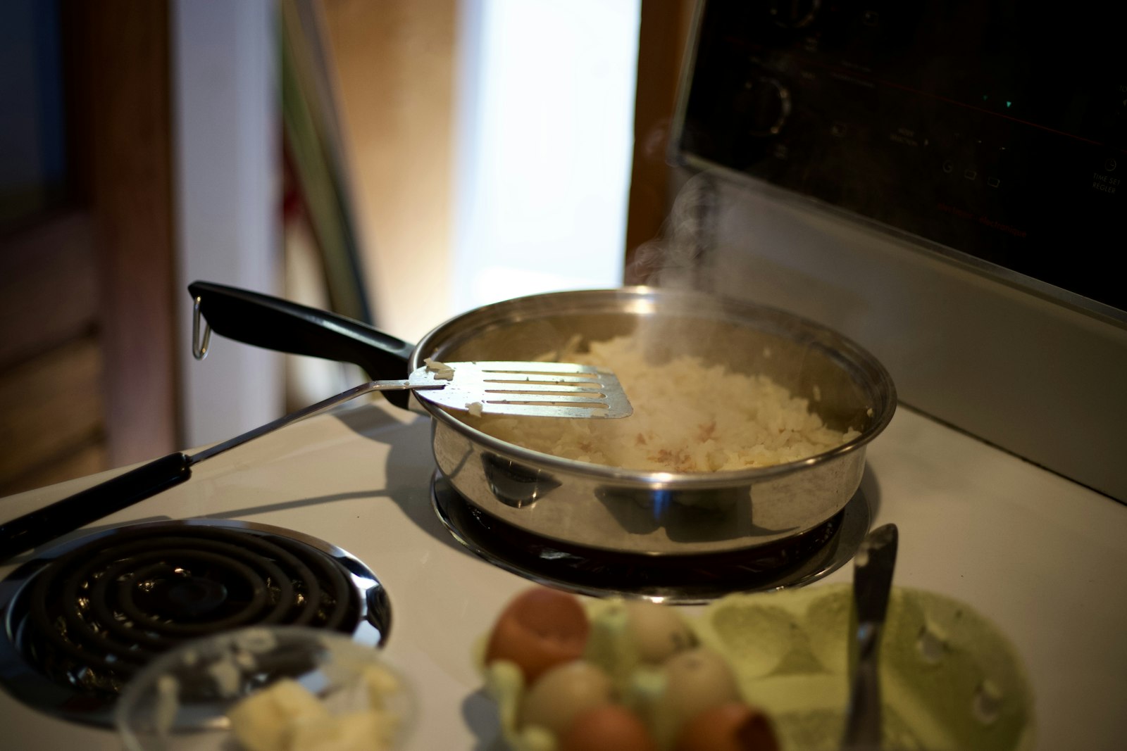 Stainless steel fork on black frying pan
