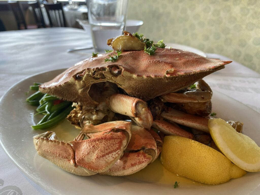 Brown and white crab on white ceramic plate
