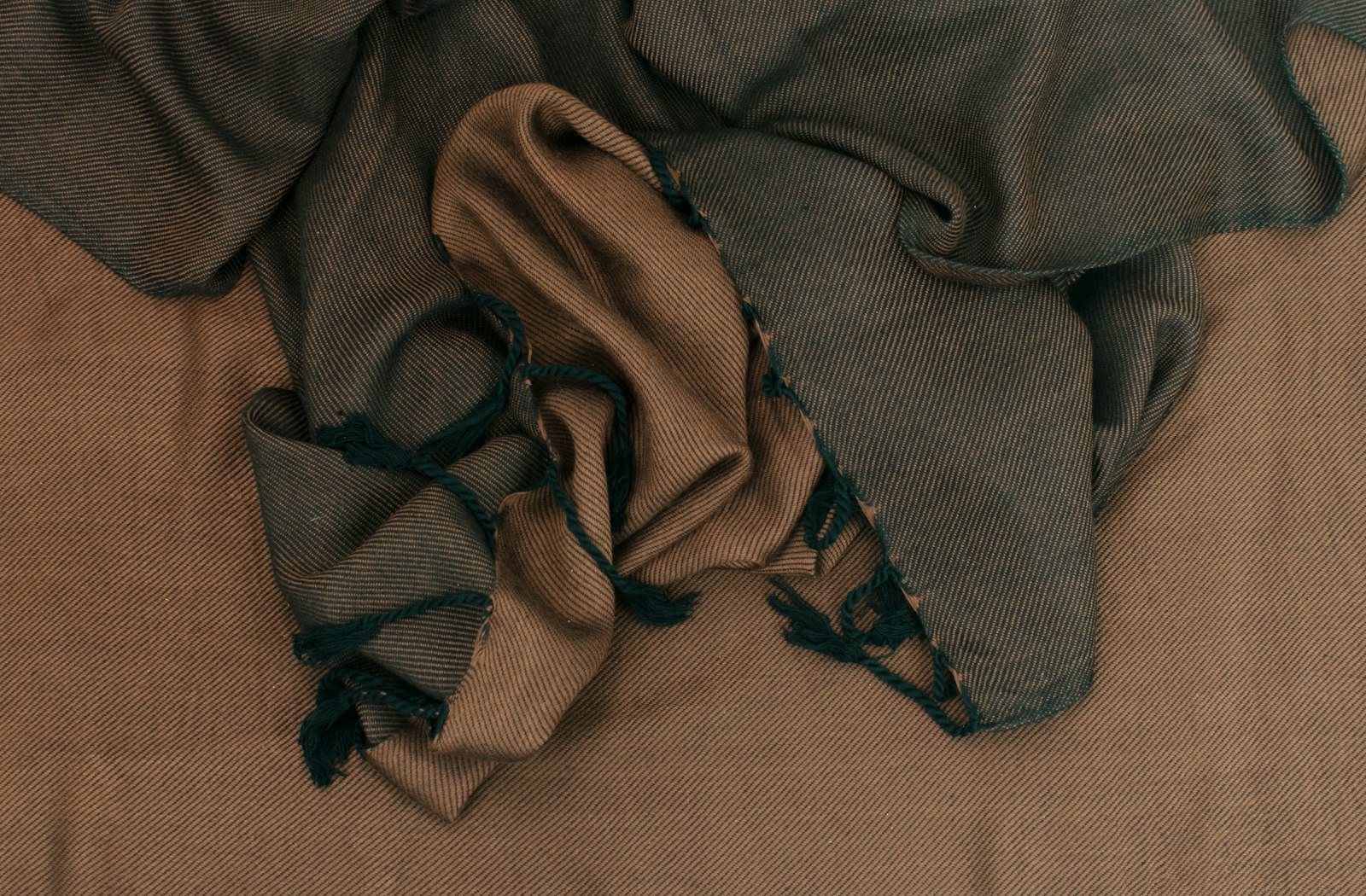 A pile of cloth sitting on top of a bed