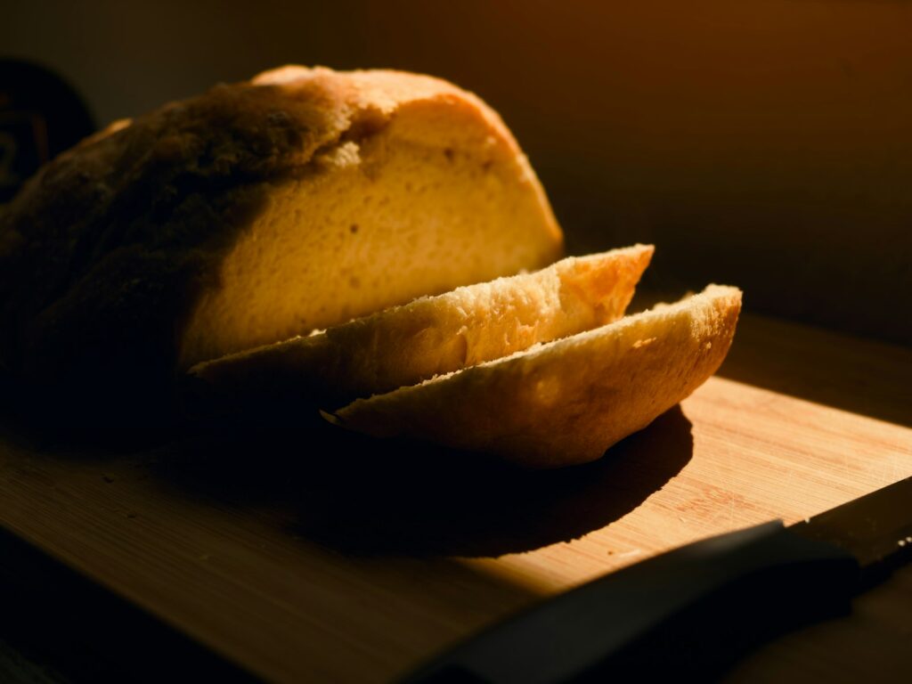 Sliced loaf of bread on a wooden cutting board