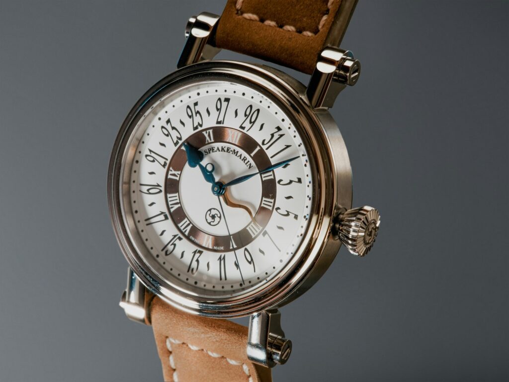 A close up of a wrist watch with a brown strap