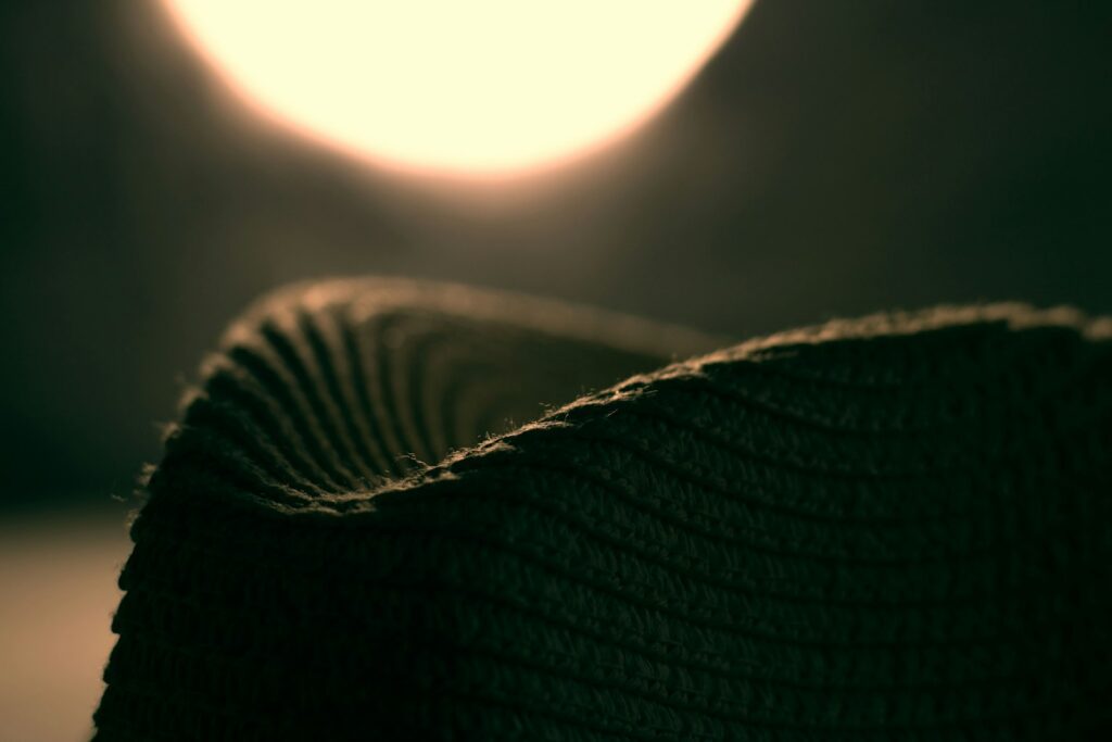 A hat is silhouetted against the sun
