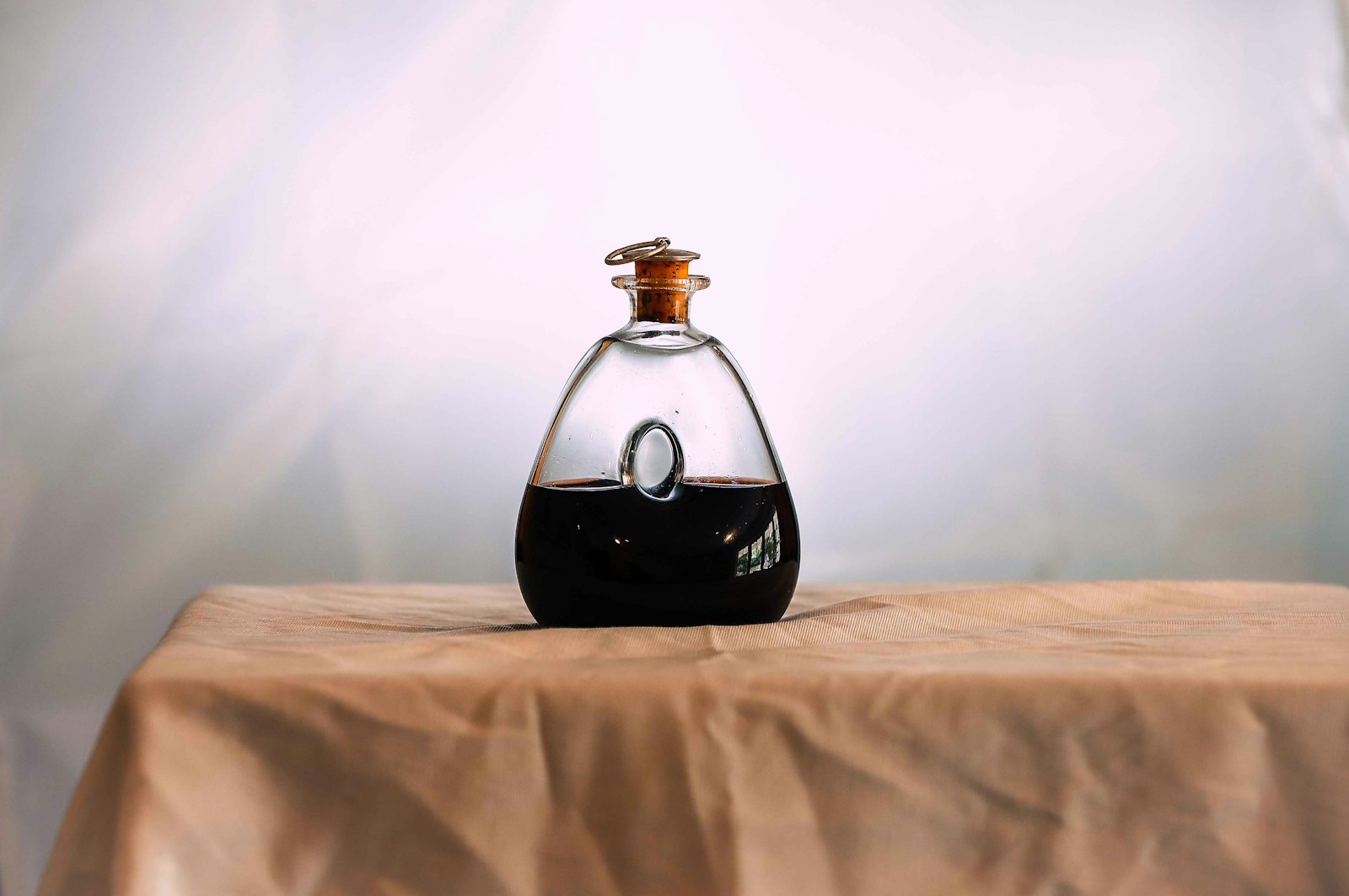 Black and white labeled bottle on brown textile