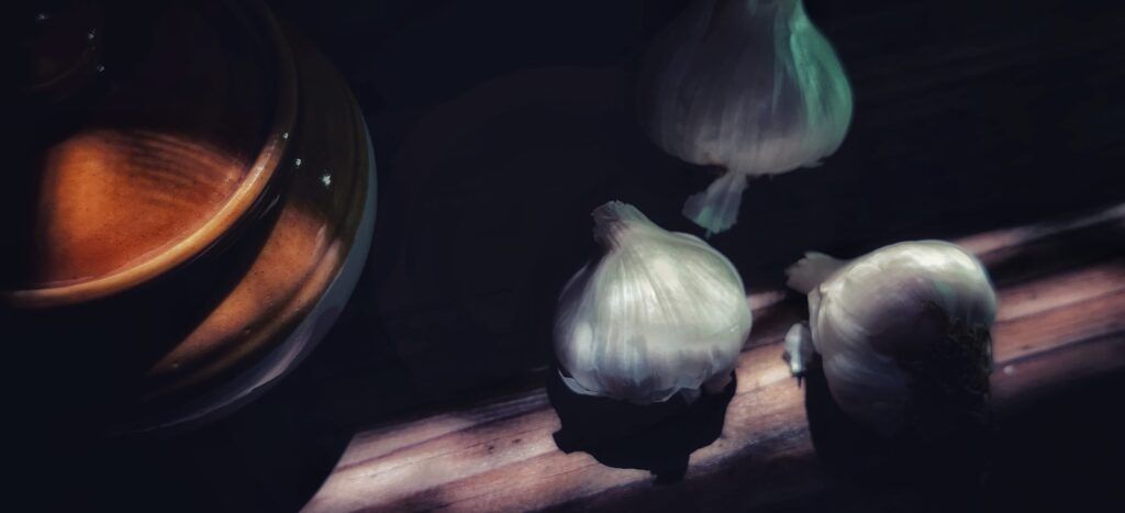 White garlic on brown wooden table