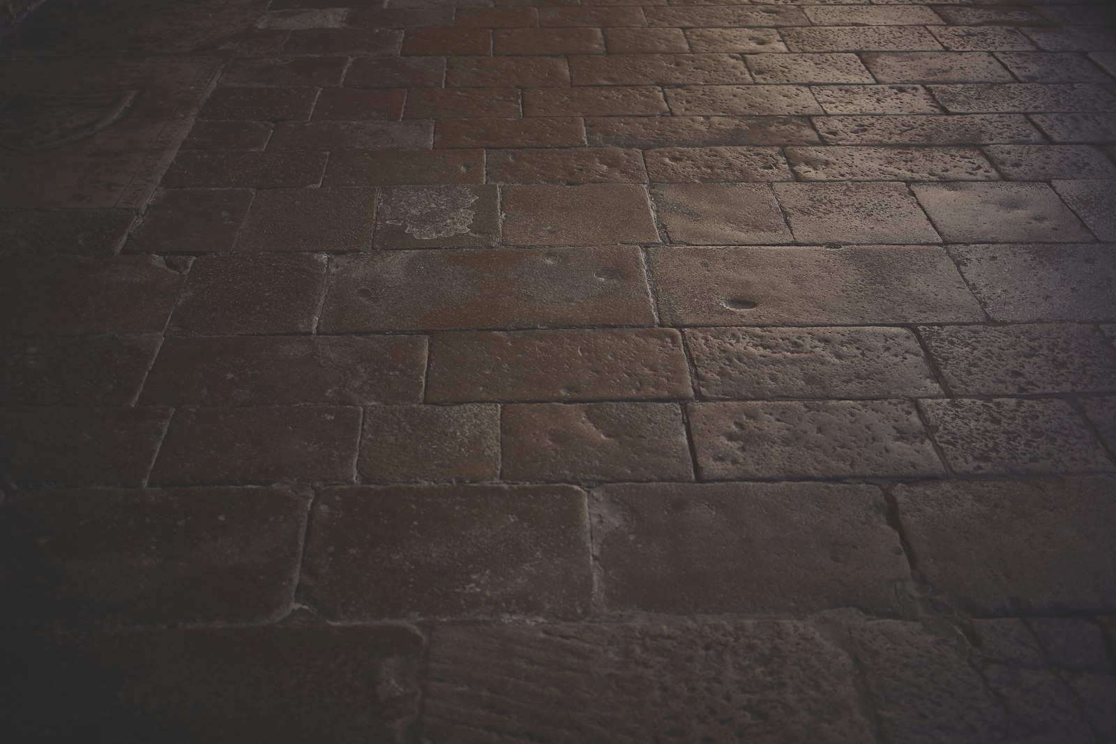 A brick floor with a light shining on it