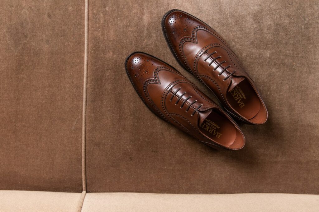 Brown leather shoes on brown floor tiles