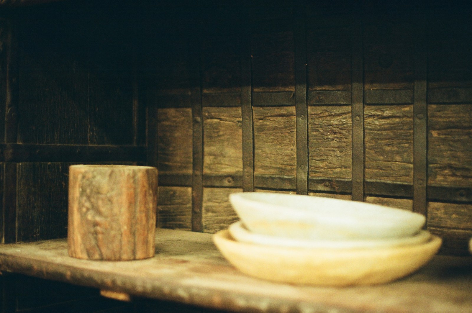 Wooden block and bowls on a rustic shelf