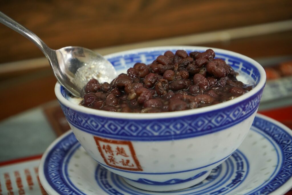 A bowl of beans with a spoon in it