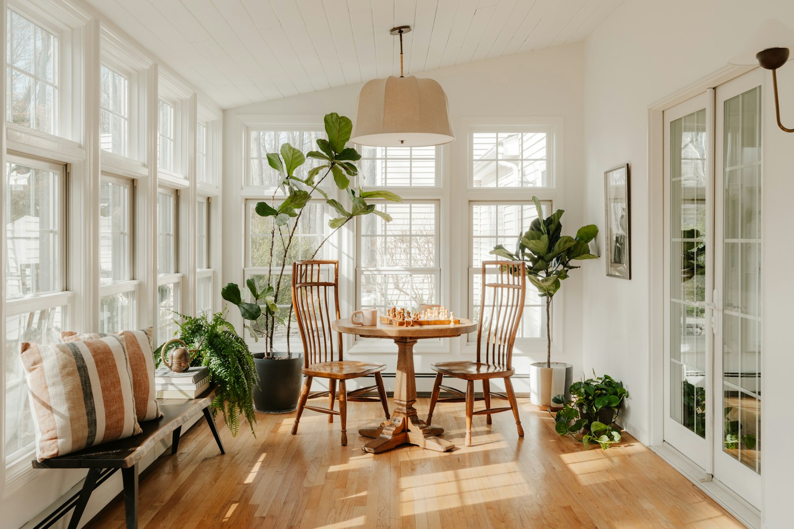 Bright sunroom with plants and dining table