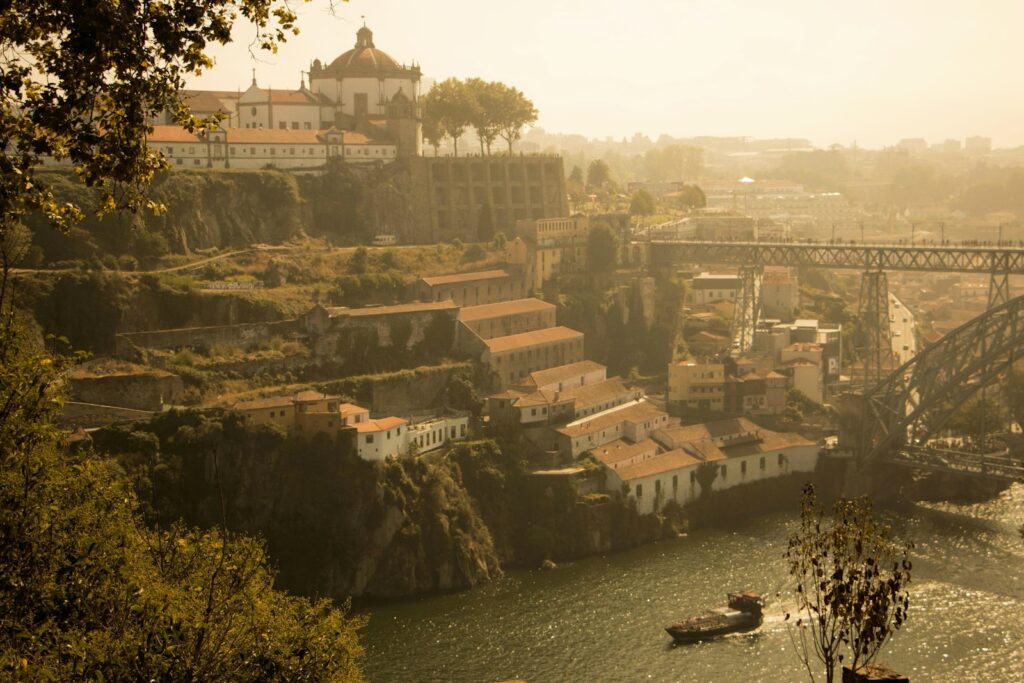 Historic buildings on a riverbank with a bridge