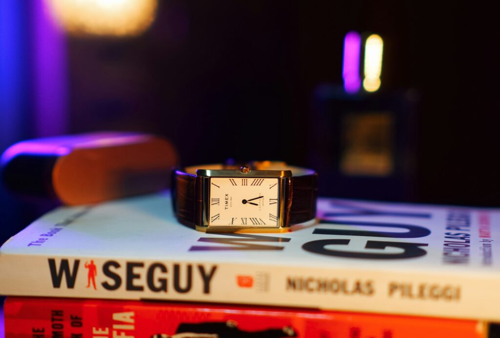 A watch on top of a stack of books