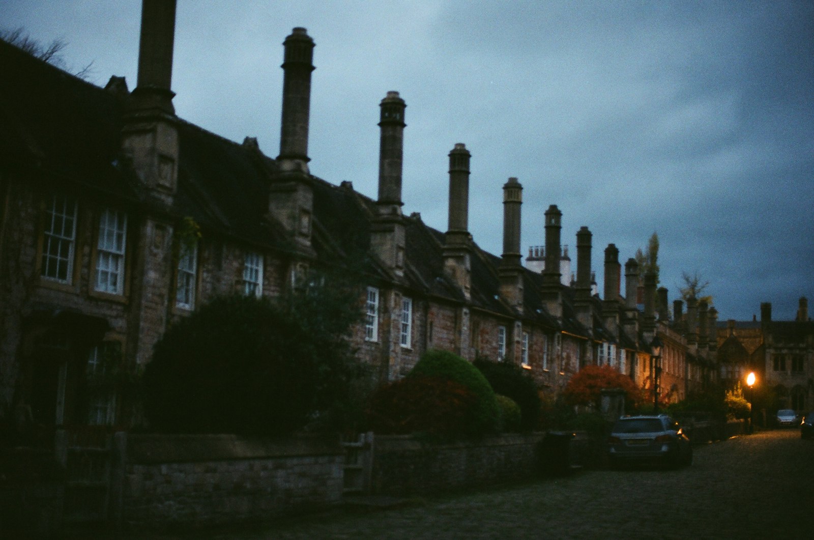 Row of historic houses with chimneys at dusk