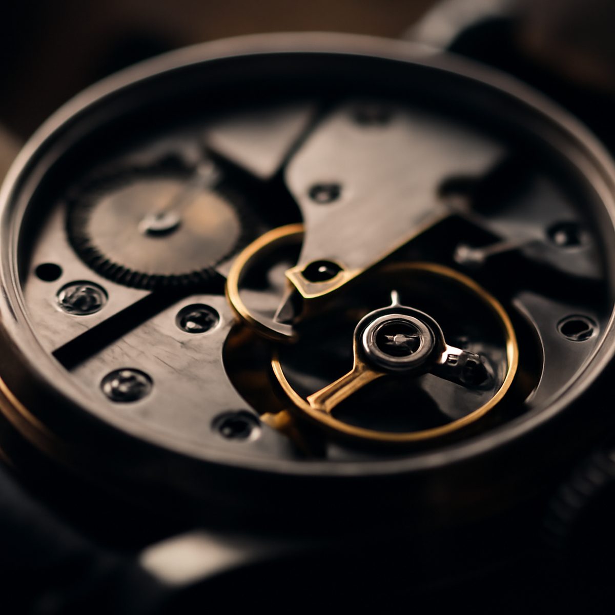 Mechanical watch movement exposed showing balance wheel and shock protection